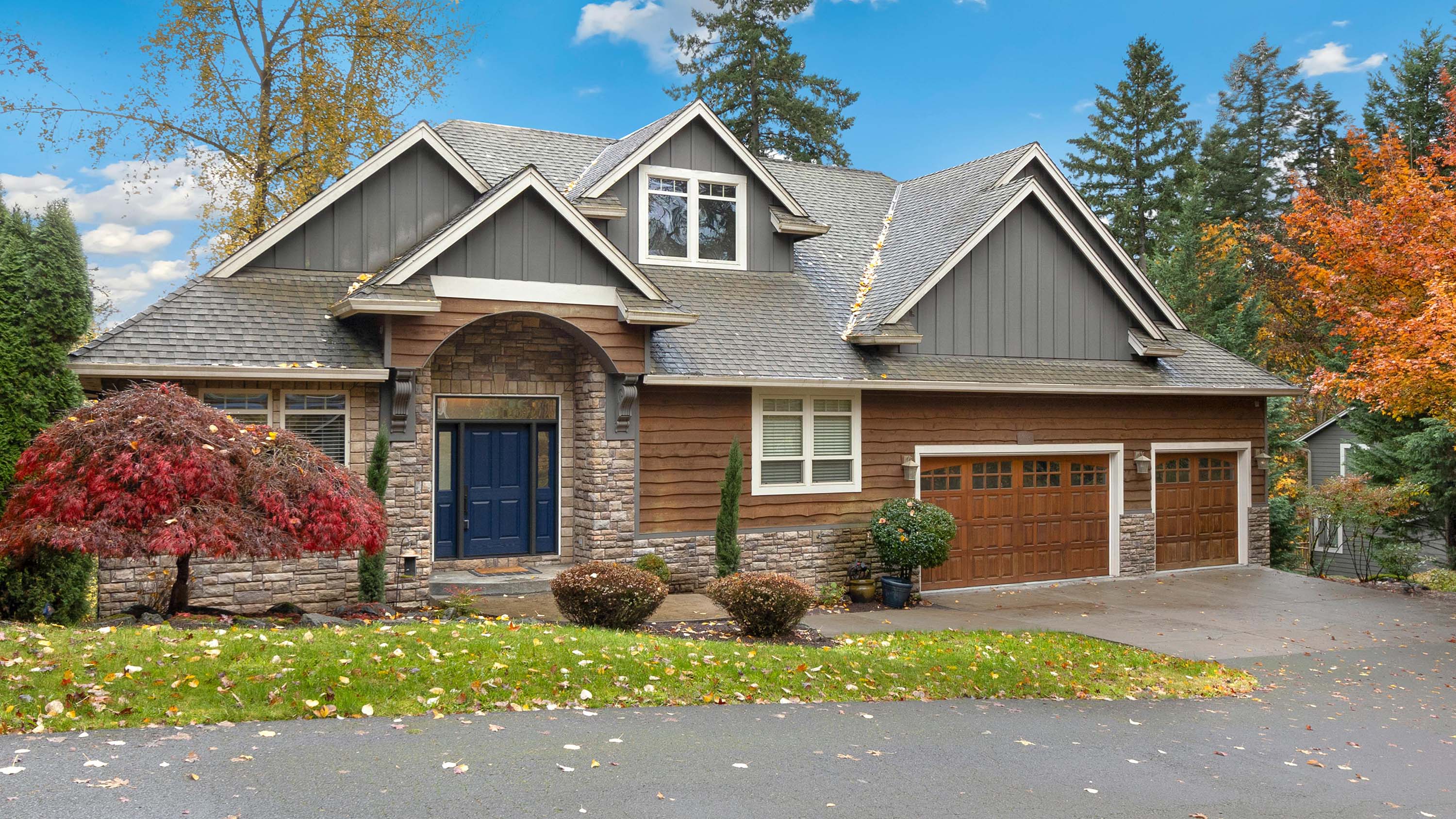 traditional beautiful house with blue siding and wooden accents