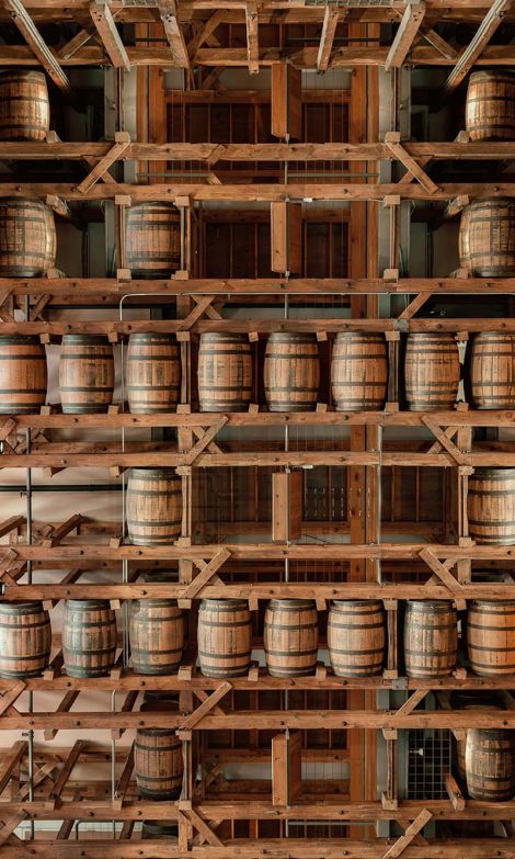 wine barrels stacked on top of each other in a commercial environment